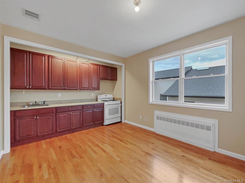 480 West Central Avenue Spring Valley, NY 10977 - Photo 10 of 35 a kitchen with stainless steel appliances granite countertop a stove a sink and a microwave