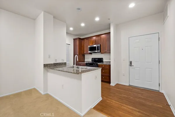 a kitchen with stainless steel appliances granite countertop a stove and a refrigerator