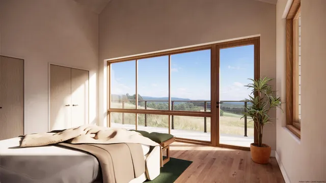 a bedroom with a large bed and a large window with balcony view