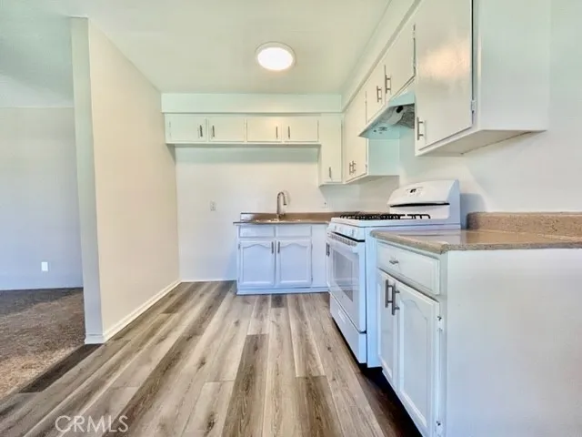 a kitchen with stainless steel appliances a stove a sink and a refrigerator