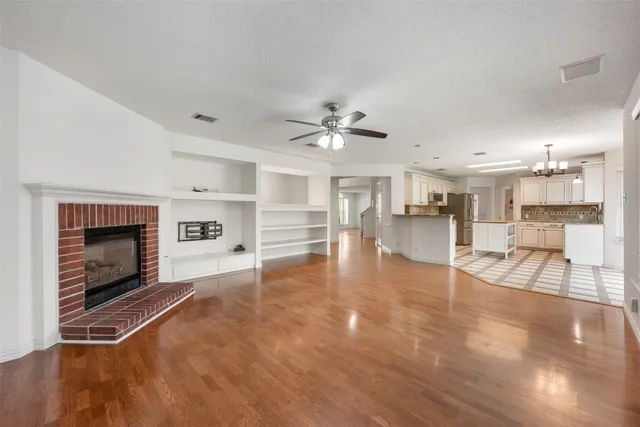 a view of open kitchen stove microwave and cabinets