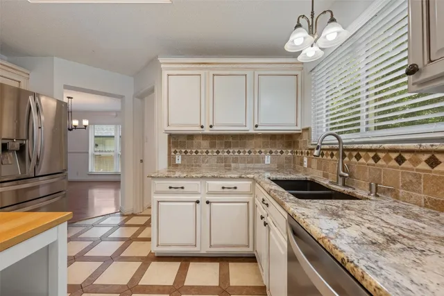 a kitchen with a stove a sink and a refrigerator