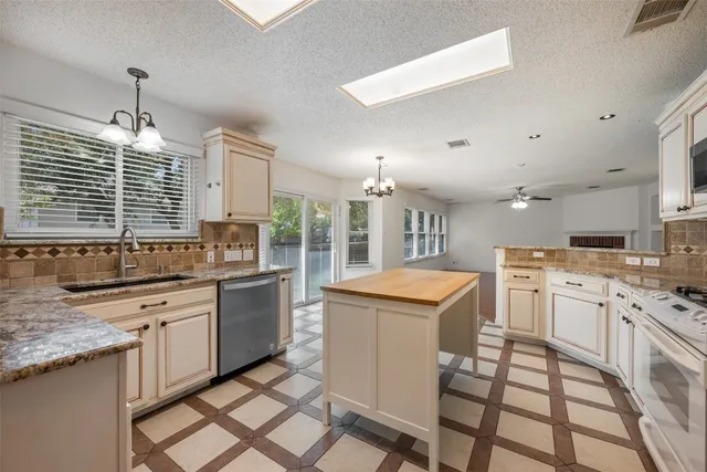 a kitchen with a stove a sink and a refrigerator