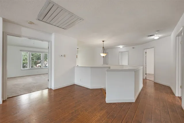 a view of kitchen with kitchen island and stainless steel appliances