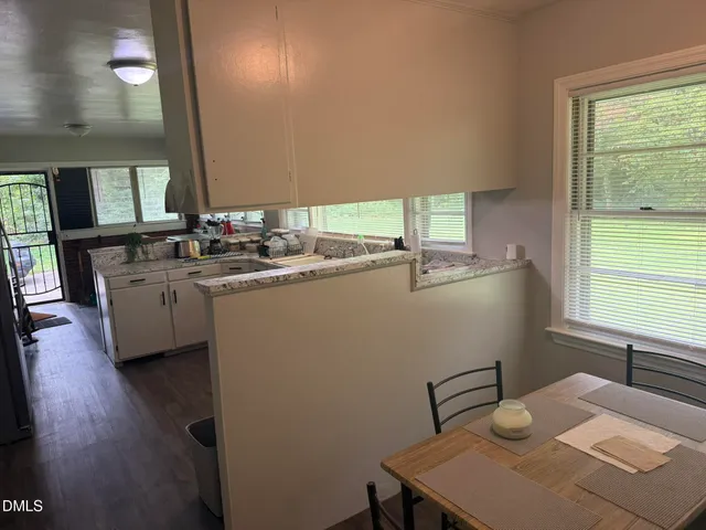 a kitchen with sink cabinets and wooden floor