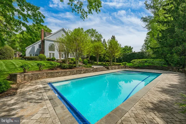 a view of a swimming pool with a yard
