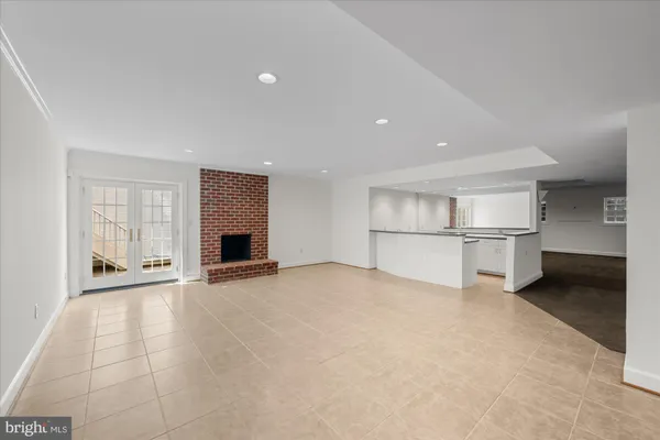 a view of a kitchen with a refrigerator and a stove top oven