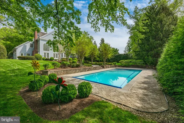 a view of a backyard with swimming pool