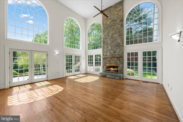 a view of empty room with wooden floor and fireplace