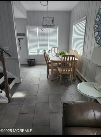 a dining room with furniture and wooden floor