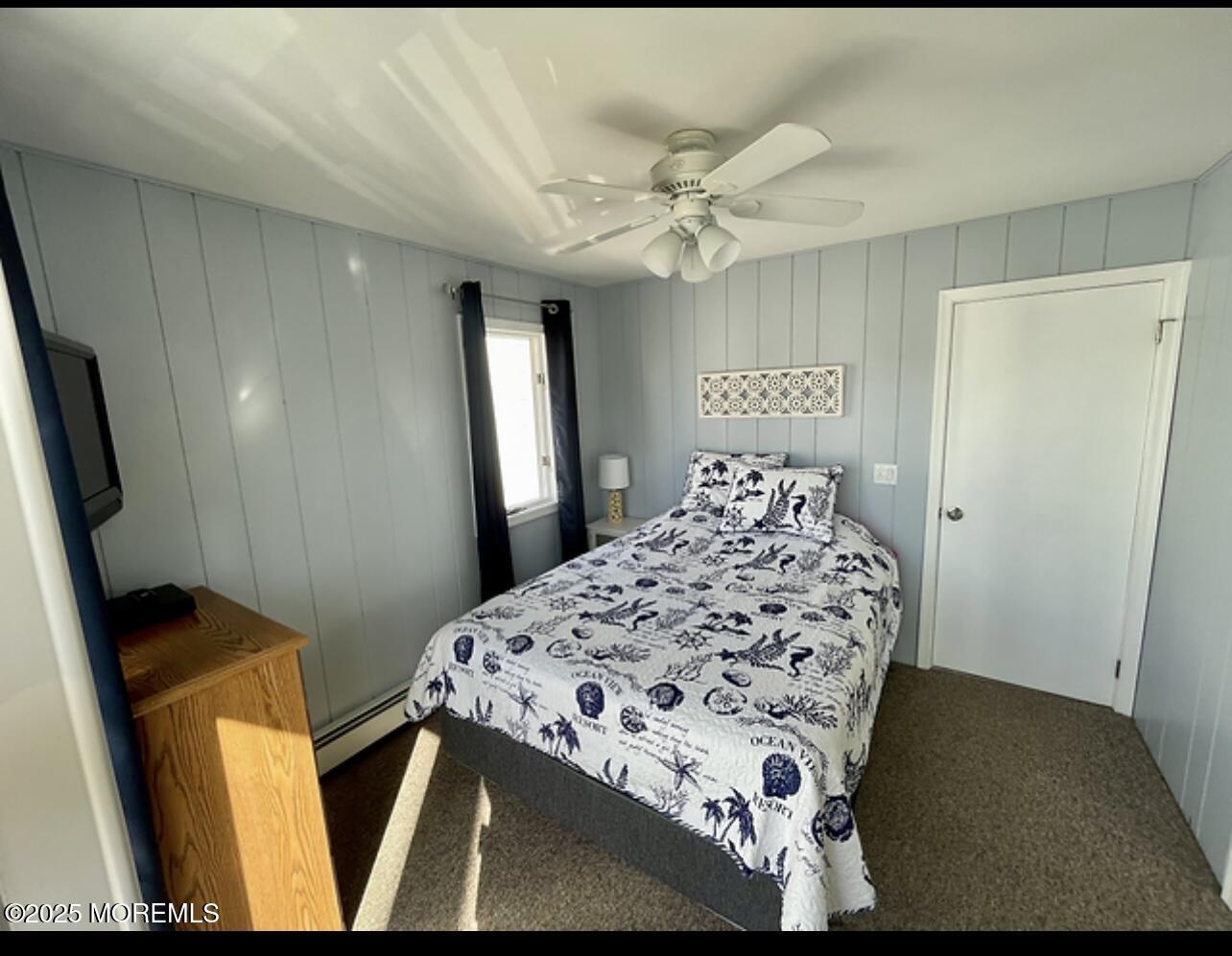 23 Surf Way Lavallette, NJ 08735 - Photo 20 of 26 a bedroom with a bed and a chandelier