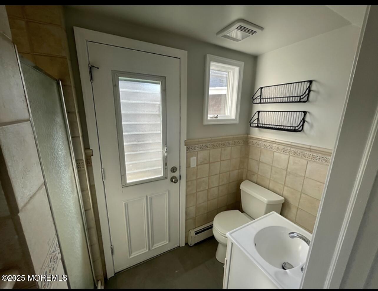 23 Surf Way Lavallette, NJ 08735 - Photo 24 of 26 a bathroom with a sink a toilet and a mirror
