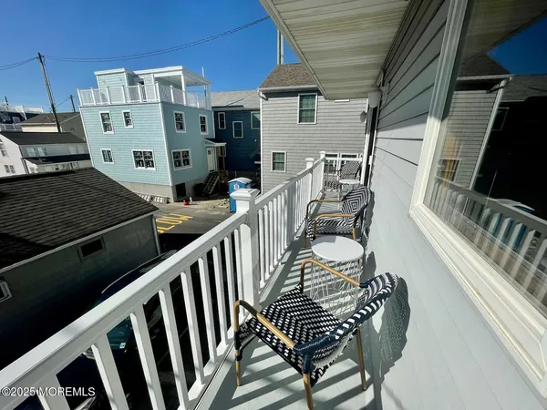 a view of a chairs and table in the balcony