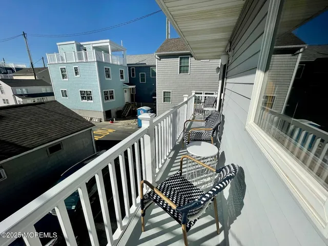 a view of a chairs and table in the balcony