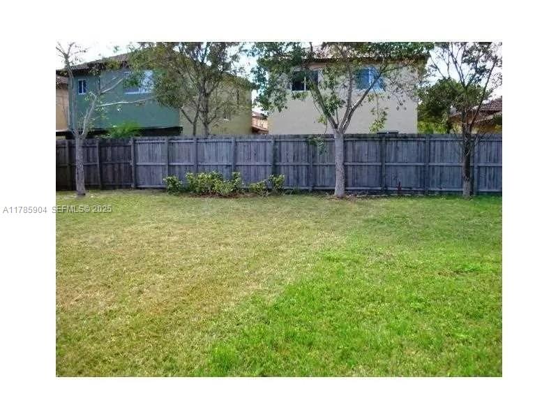 2540 Northeast 41st Terrace Homestead, FL 33033 - Photo 11 of 12 a view of a backyard with wooden fence