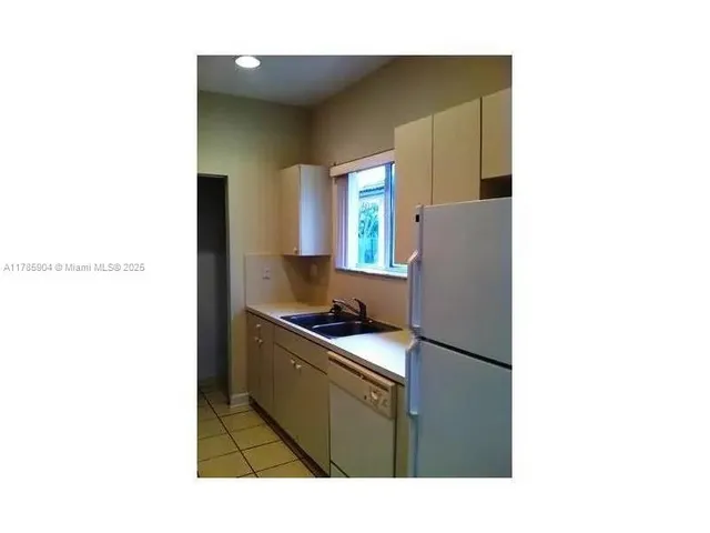 a kitchen with a stove and a refrigerator