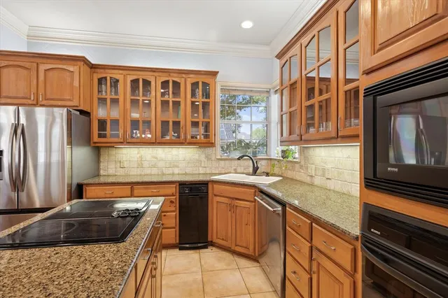 a kitchen with a sink stove and cabinets
