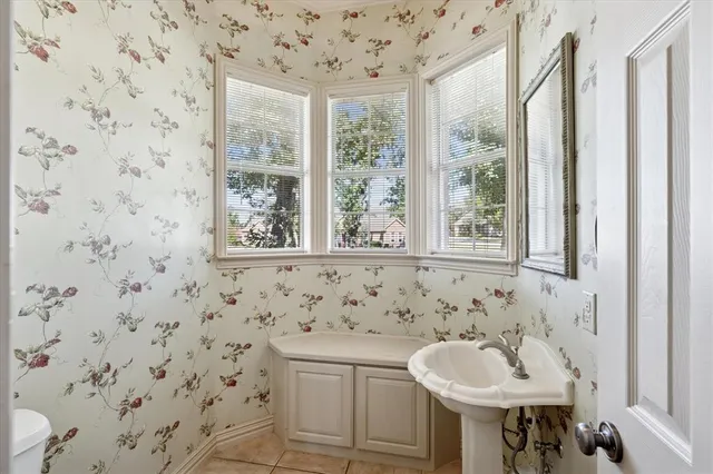 a bathroom with a sink a toilet and a window