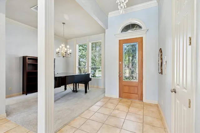 a view of a hallway with furniture and a chandelier