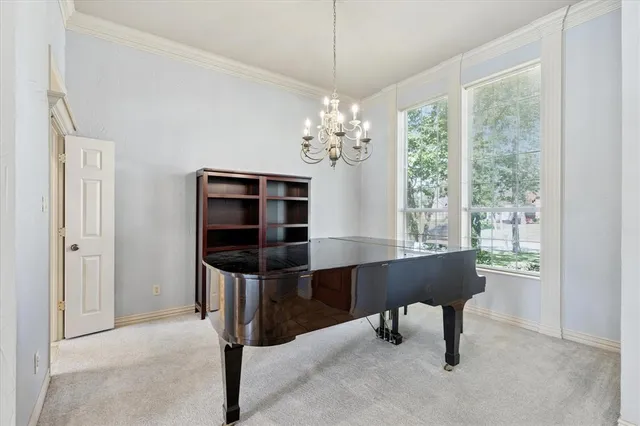 a room with chandelier and window