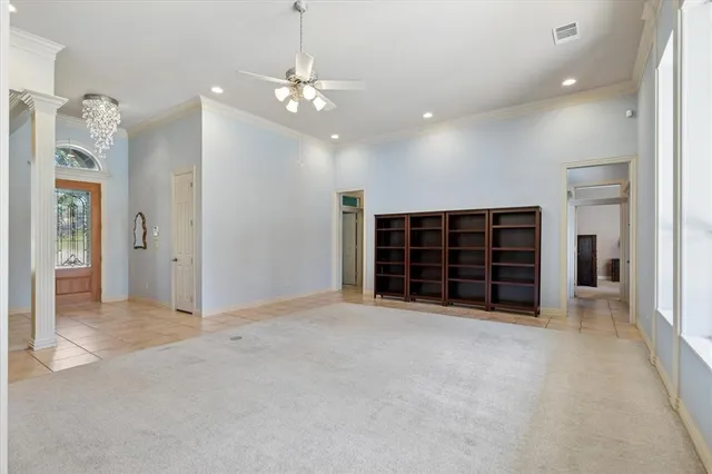 an empty room with windows and cabinet