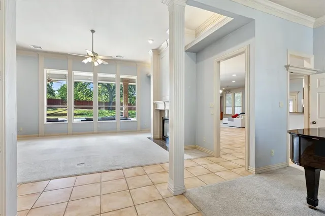 a very nice looking empty room with window and chandelier
