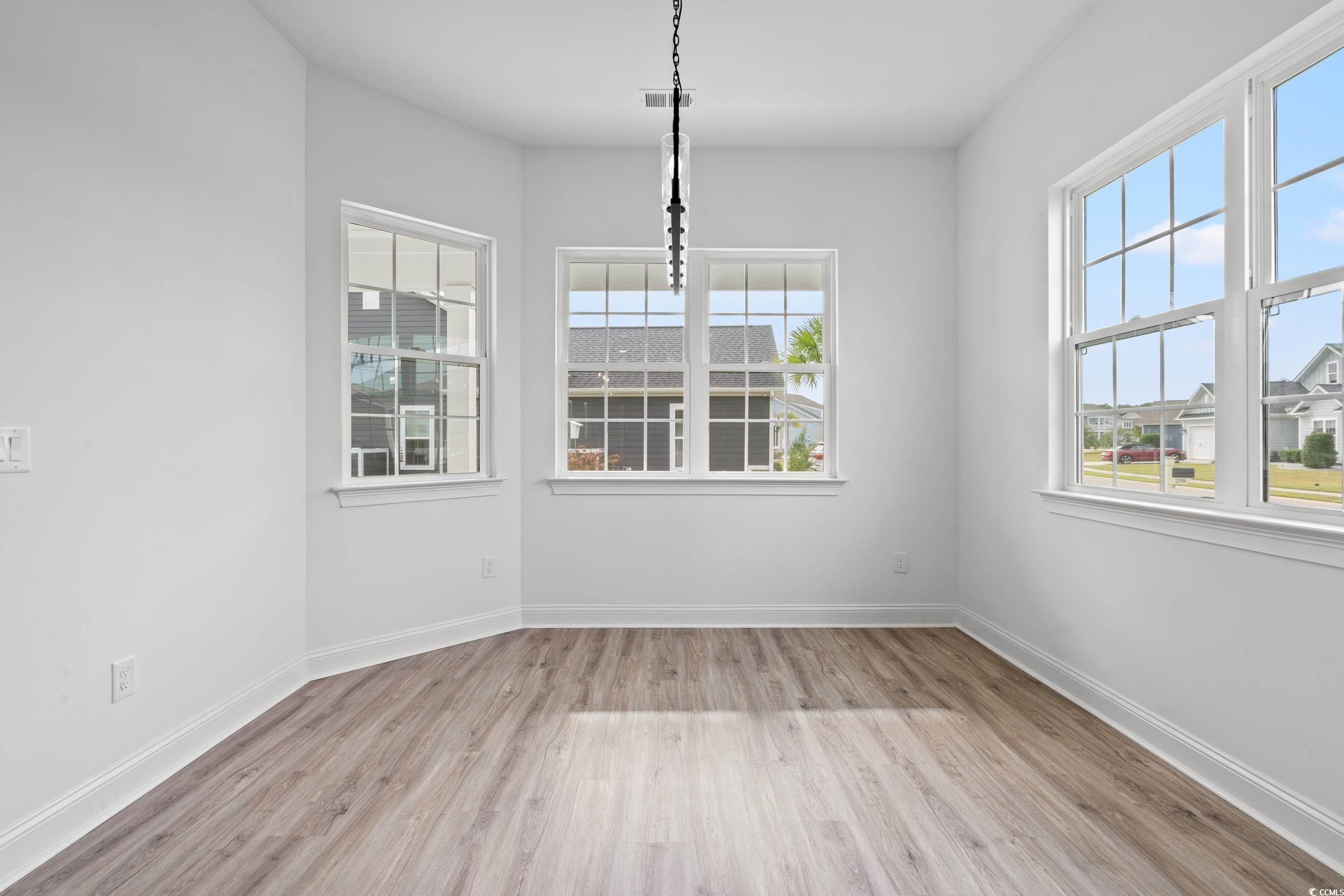 1009 Englemann Oak Drive Myrtle Beach, SC 29579 - Photo 10 of 38 Unfurnished dining area with light wood-style floors and plenty of natural light