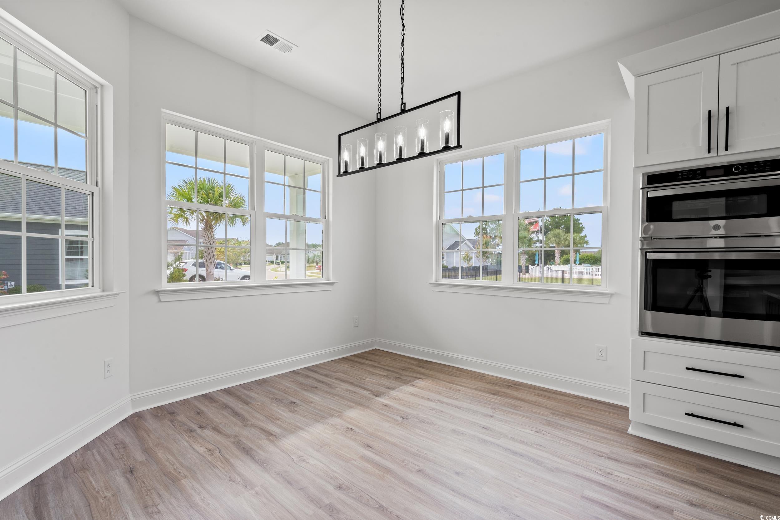 1009 Englemann Oak Drive Myrtle Beach, SC 29579 - Photo 12 of 38 Unfurnished dining area featuring light wood-type flooring and baseboards