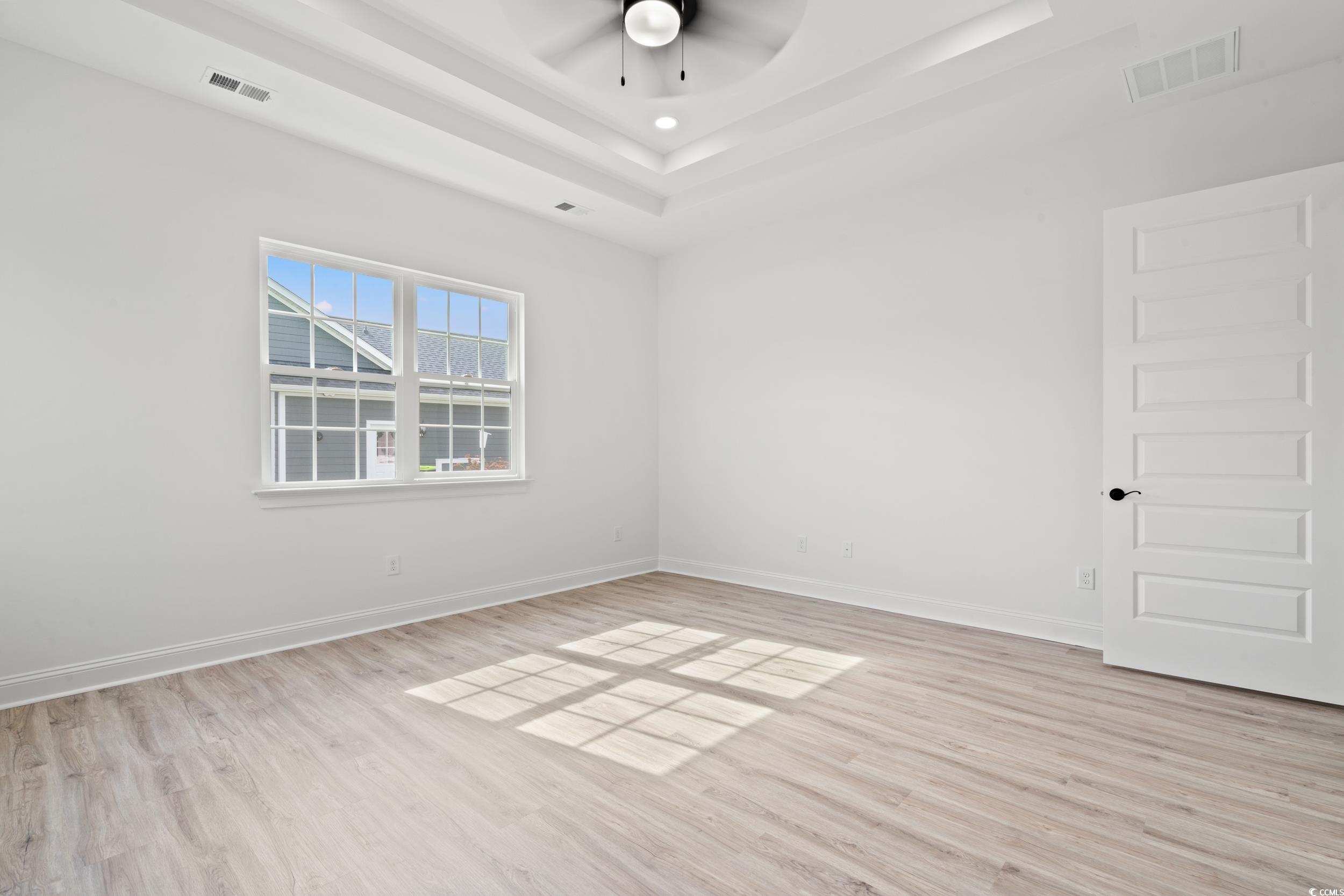 1009 Englemann Oak Drive Myrtle Beach, SC 29579 - Photo 14 of 38 Spare room with light wood finished floors, ceiling fan, and a raised ceiling
