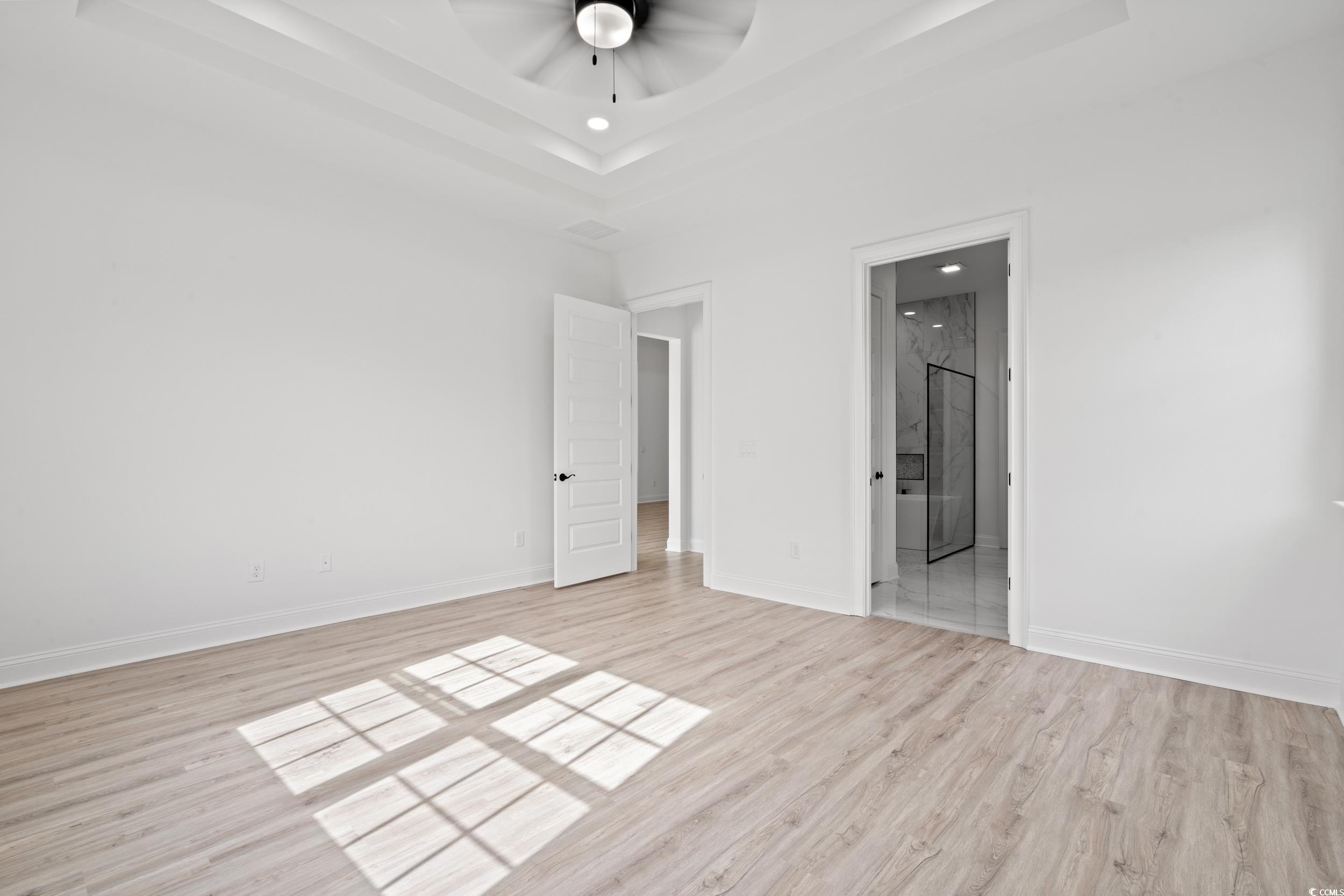1009 Englemann Oak Drive Myrtle Beach, SC 29579 - Photo 16 of 38 Unfurnished bedroom with a raised ceiling, light wood finished floors, ceiling fan, recessed lighting, and ensuite bath