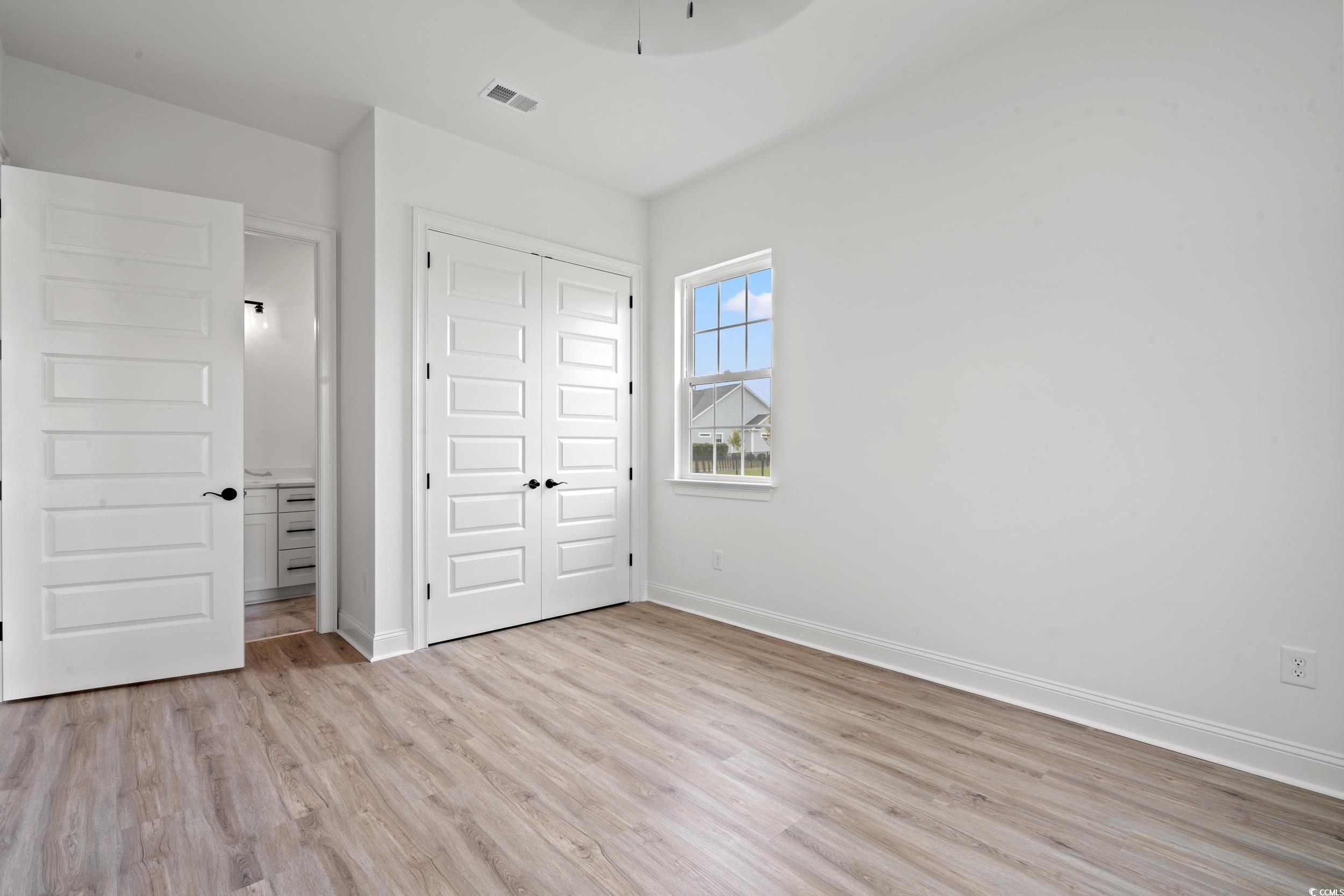 1009 Englemann Oak Drive Myrtle Beach, SC 29579 - Photo 22 of 38 Unfurnished bedroom featuring light wood-type flooring and a closet