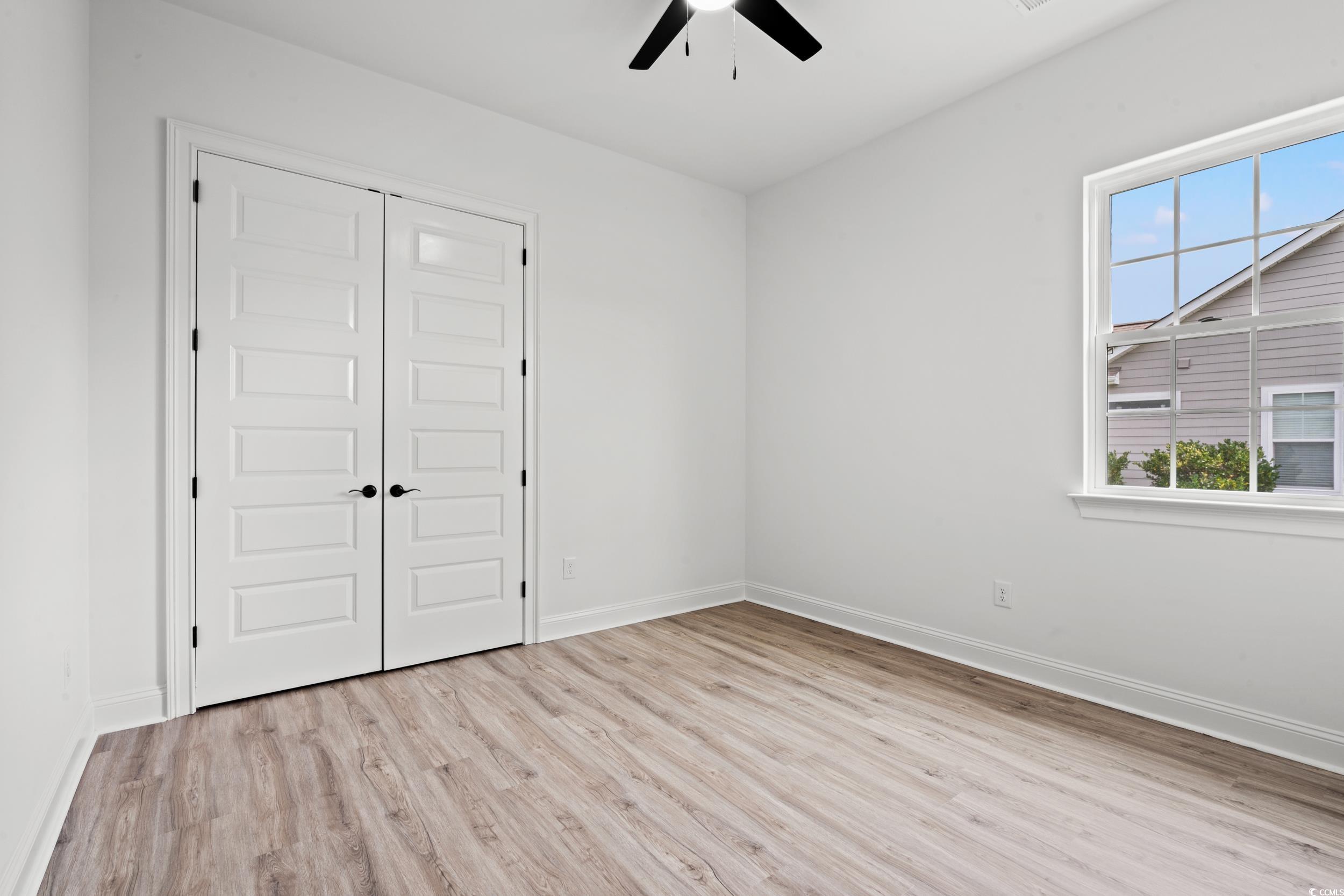 1009 Englemann Oak Drive Myrtle Beach, SC 29579 - Photo 29 of 38 Empty room with light wood-style floors and ceiling fan