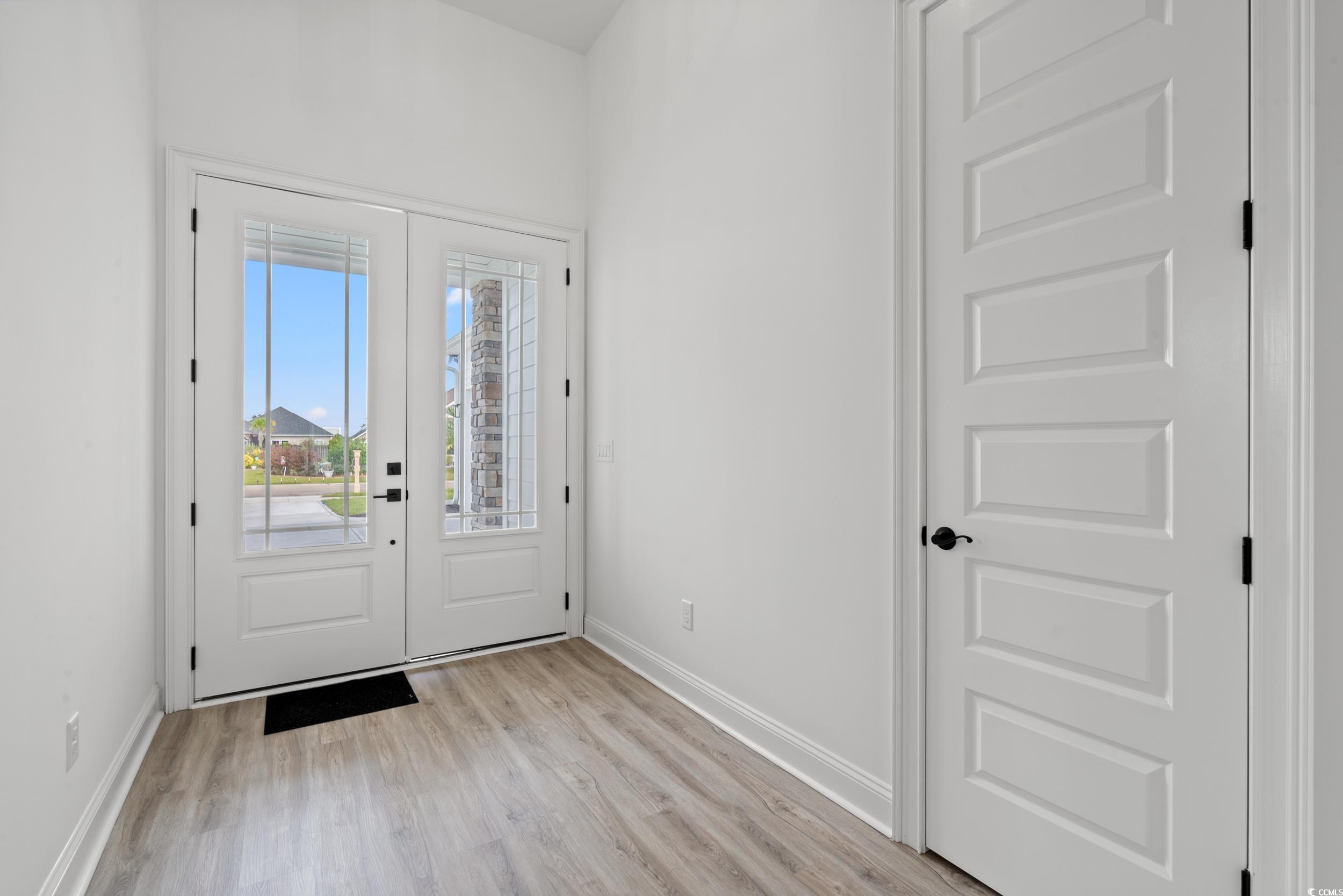 1009 Englemann Oak Drive Myrtle Beach, SC 29579 - Photo 3 of 38 Doorway featuring baseboards and wood finished floors