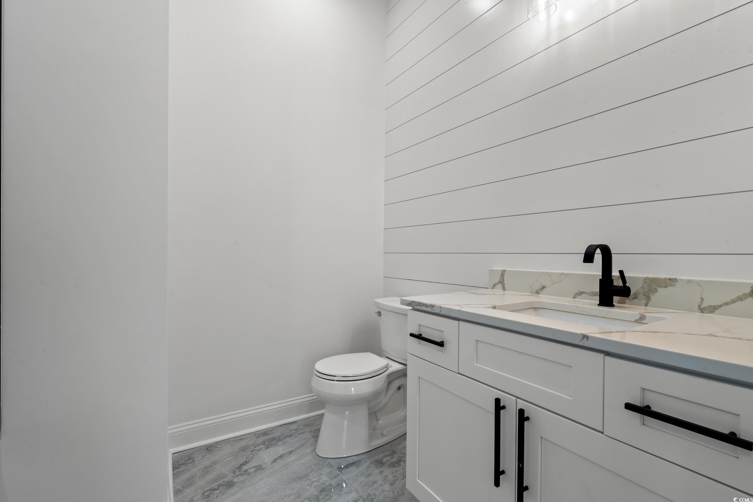 1009 Englemann Oak Drive Myrtle Beach, SC 29579 - Photo 30 of 38 Half bath featuring vanity and wooden walls