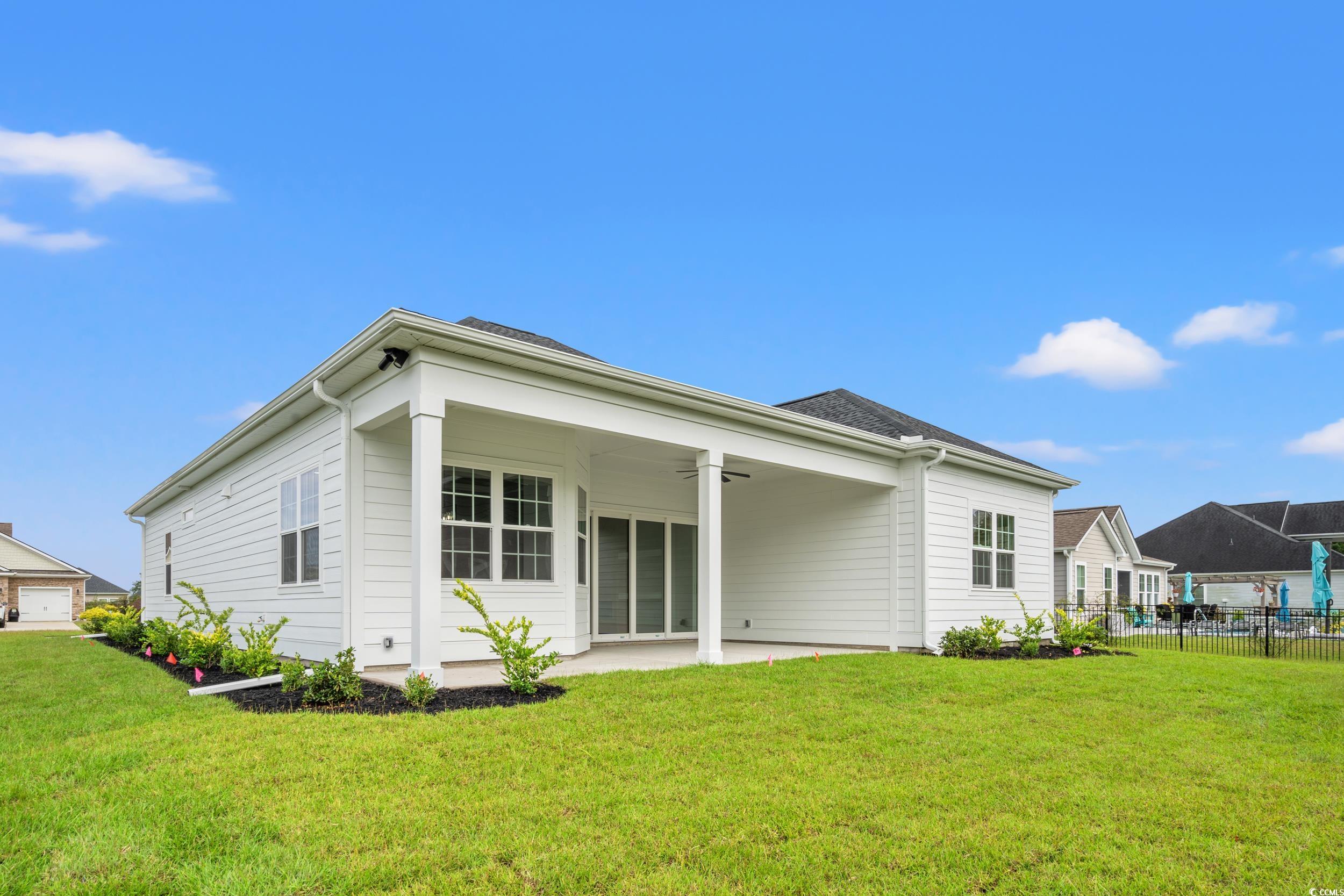 1009 Englemann Oak Drive Myrtle Beach, SC 29579 - Photo 33 of 38 Rear view of house with ceiling fan and a patio area