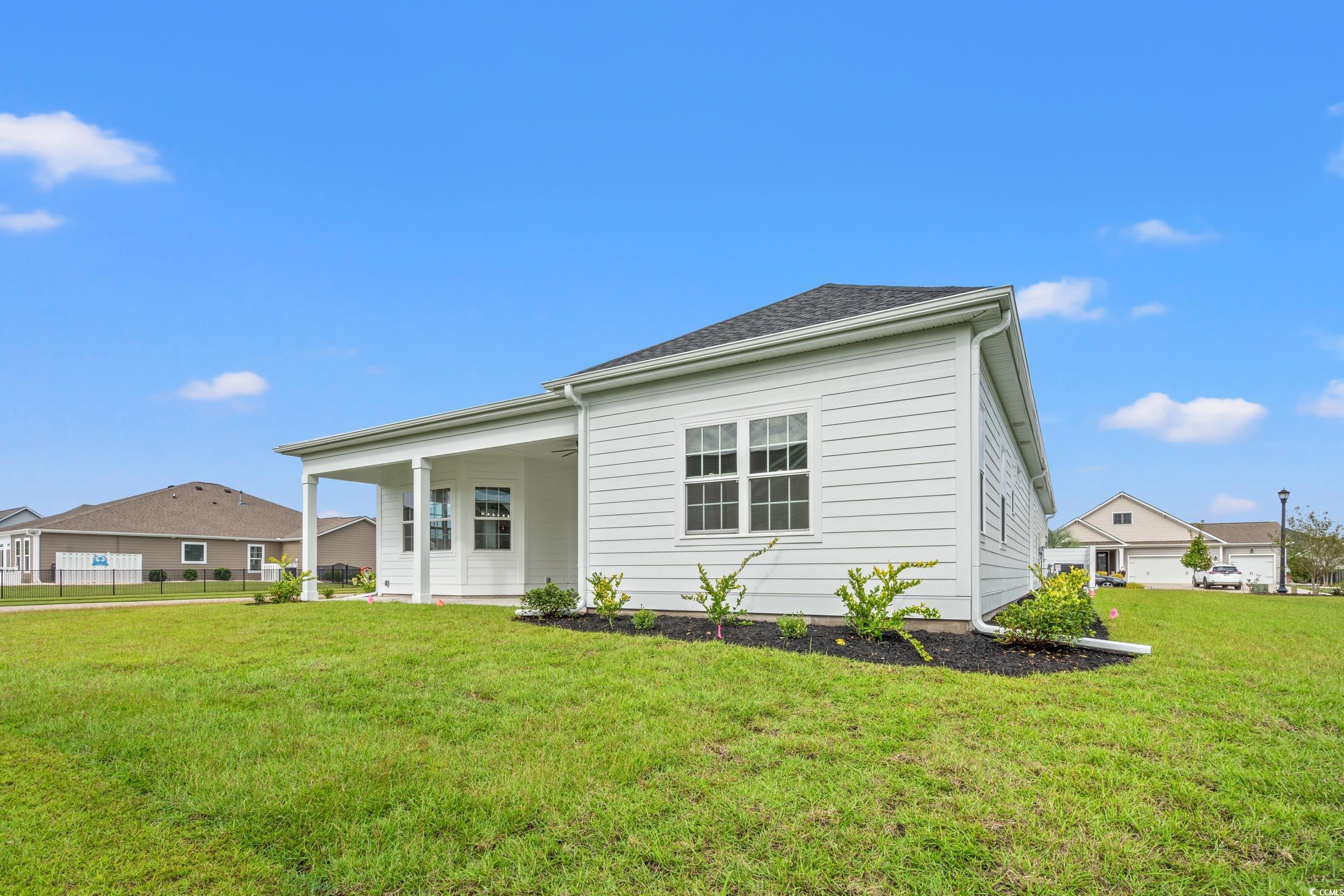 1009 Englemann Oak Drive Myrtle Beach, SC 29579 - Photo 34 of 38 Back of property with a lawn