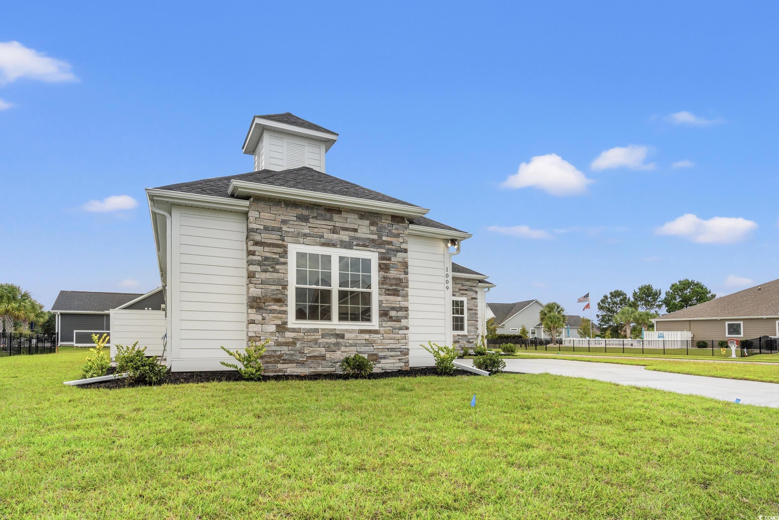 1009 Englemann Oak Drive Myrtle Beach, SC 29579 - Photo 35 of 38 View of side of home with stone siding and roof with shingles