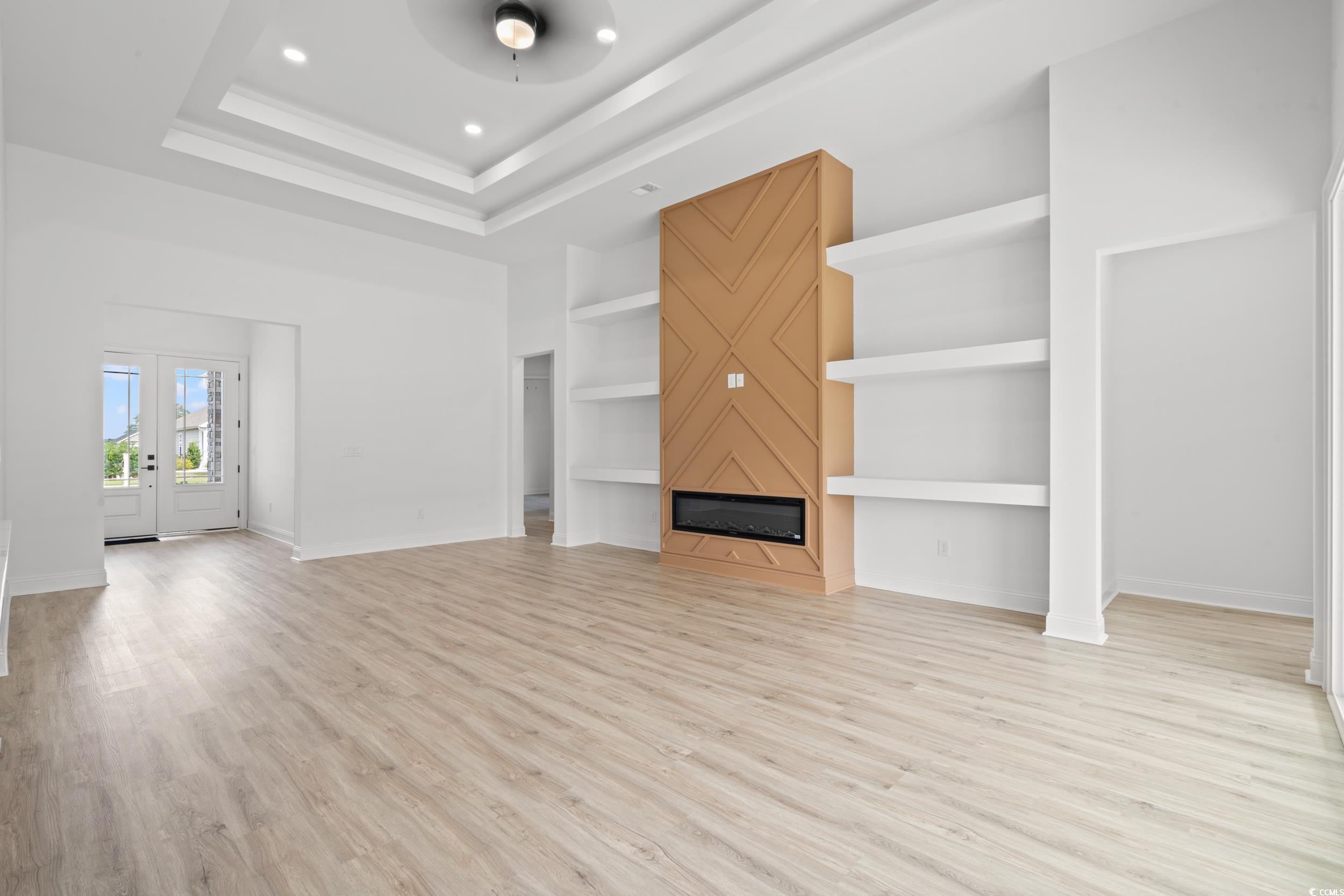 1009 Englemann Oak Drive Myrtle Beach, SC 29579 - Photo 4 of 38 Unfurnished living room with a fireplace, light wood-style floors, french doors, ceiling fan, and recessed lighting