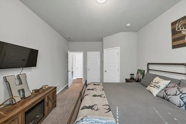 a bedroom with furniture and a potted plant