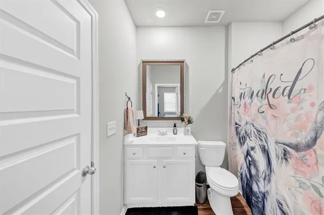 a spacious bathroom with a double vanity sink a mirror and shower