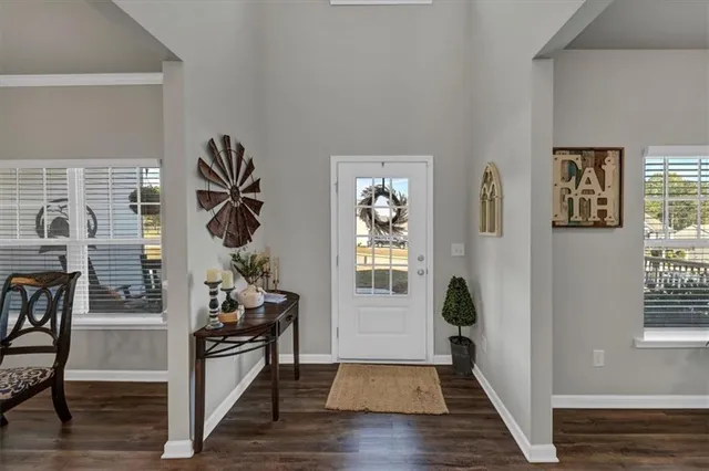 a view of an entryway with wooden floor and a livingroom