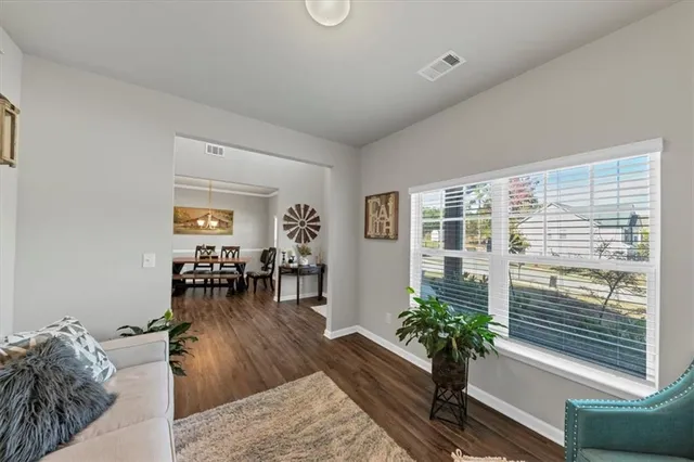 a living room with furniture and a wooden floor