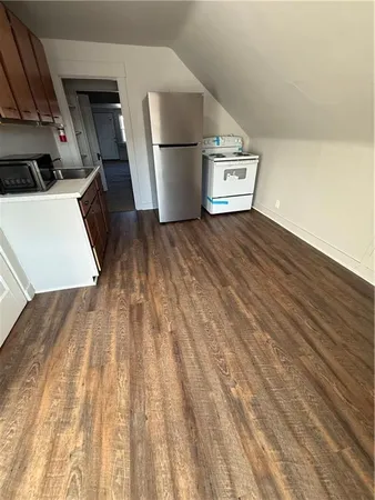 a view of a kitchen with wooden floor