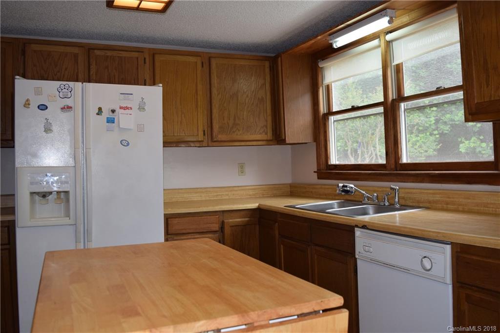 301 Weeks Road Rutherfordton, NC 28139 - Photo 2 of 16 a kitchen with a sink a refrigerator and cabinets