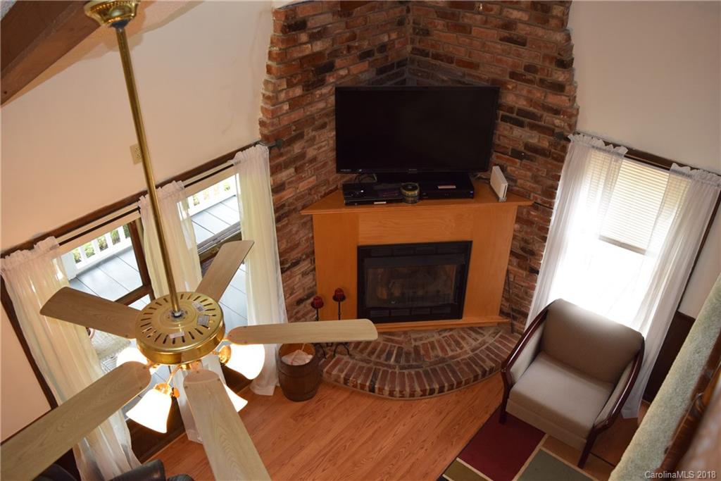 301 Weeks Road Rutherfordton, NC 28139 - Photo 11 of 16 a living room with furniture a flat screen tv and a fireplace