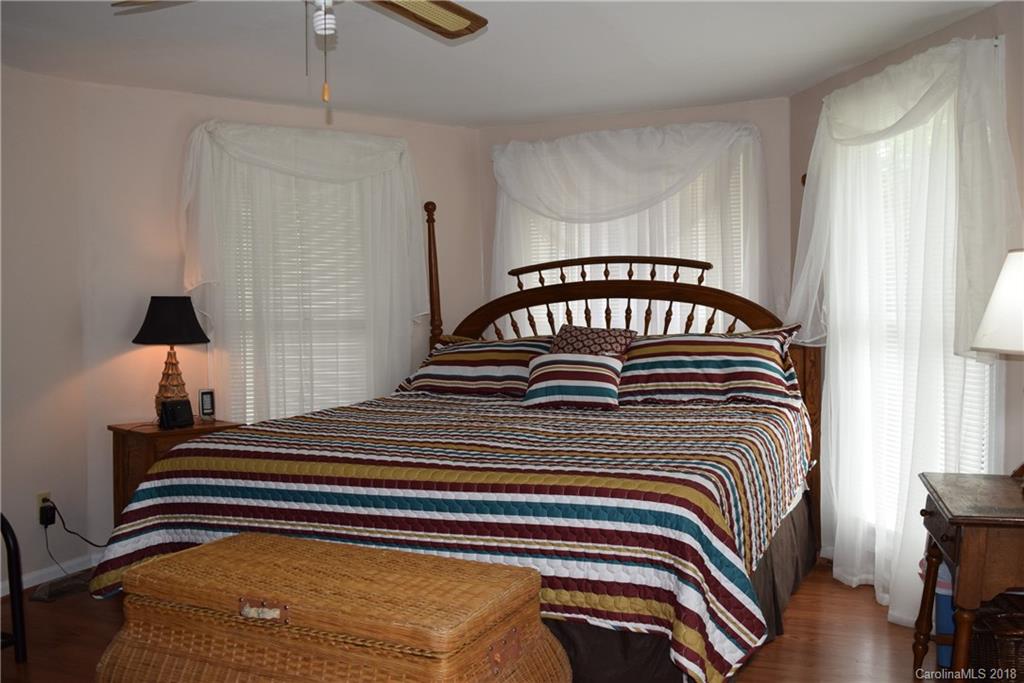 301 Weeks Road Rutherfordton, NC 28139 - Photo 4 of 16 a bedroom with a bed and a chandelier