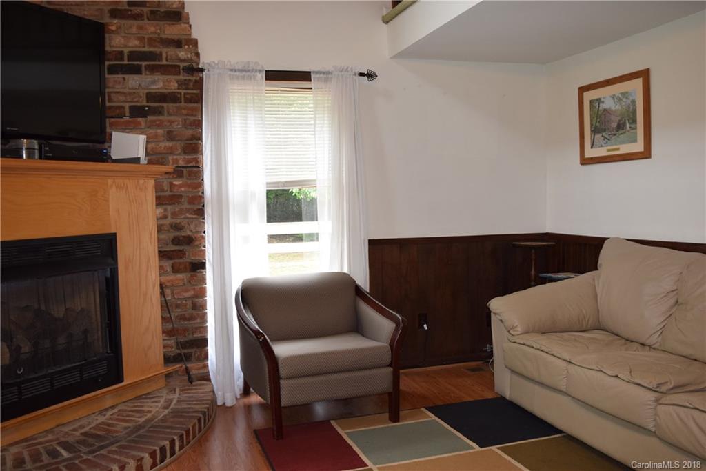 301 Weeks Road Rutherfordton, NC 28139 - Photo 5 of 16 a living room with furniture a flat screen tv and a fireplace