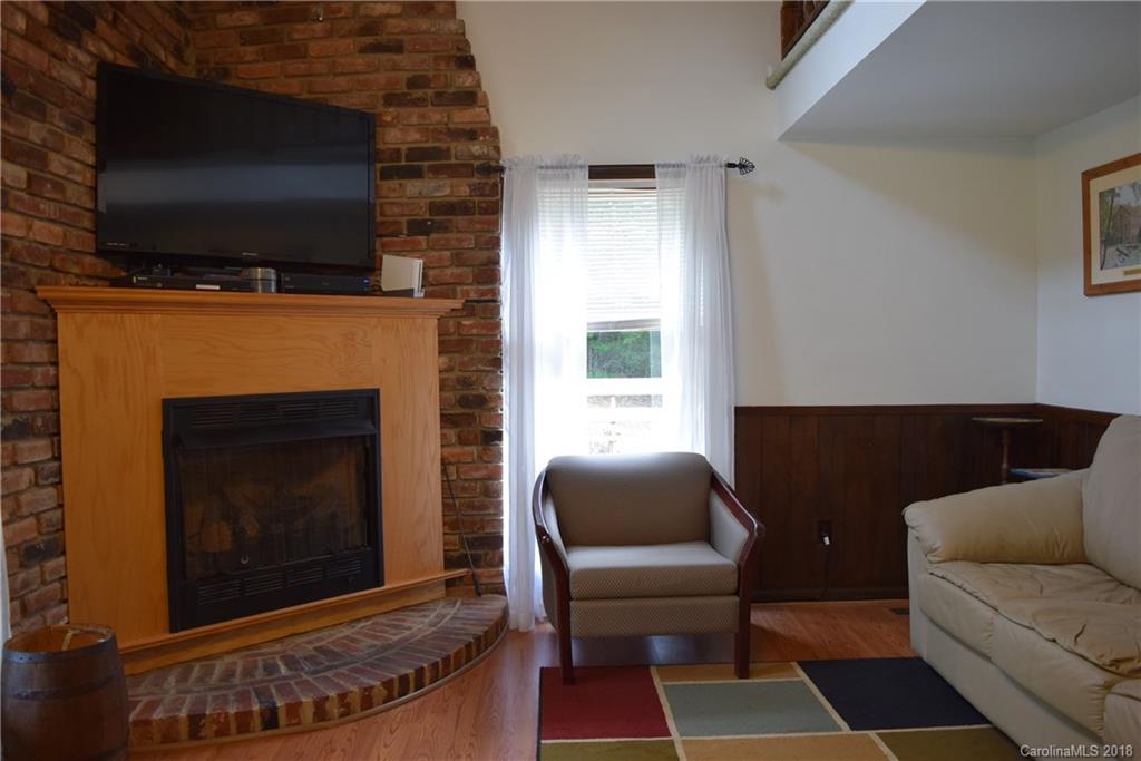301 Weeks Road Rutherfordton, NC 28139 - Photo 6 of 16 a living room with furniture a flat screen tv and a fireplace