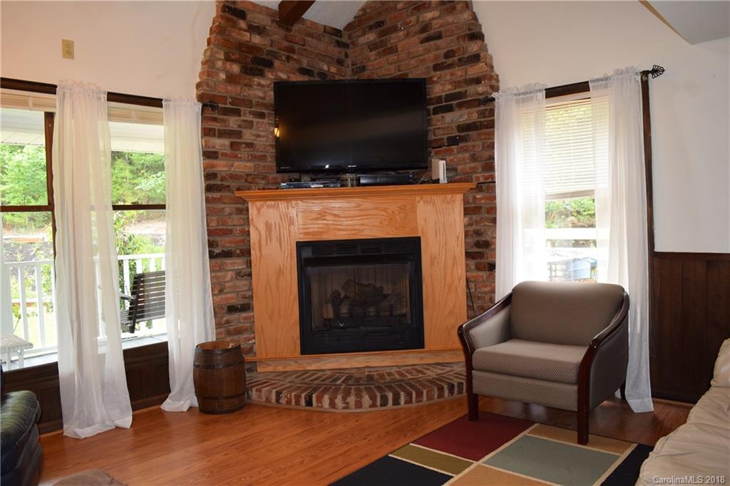 301 Weeks Road Rutherfordton, NC 28139 - Photo 7 of 16 a living room with furniture a flat screen tv and a fireplace