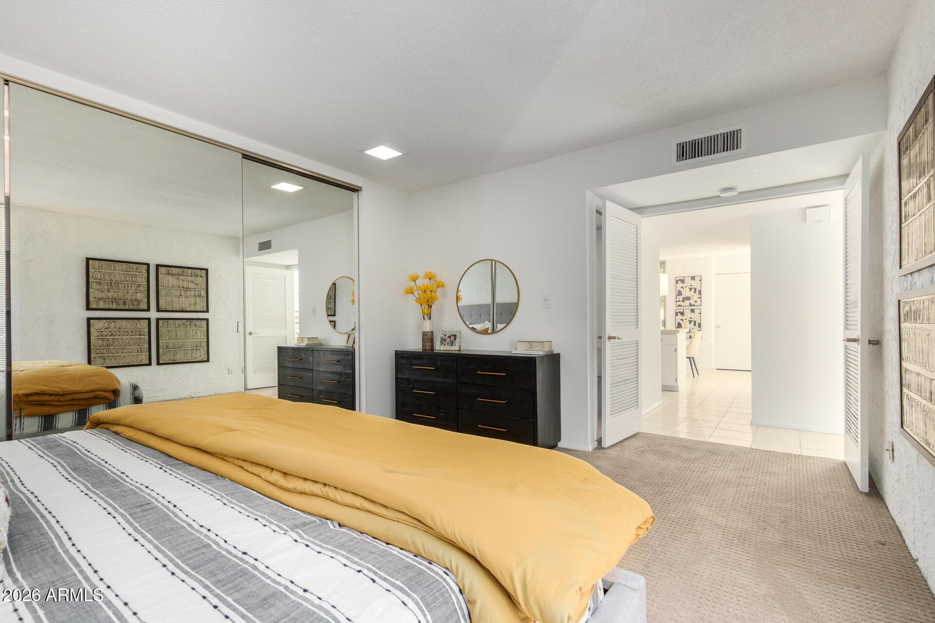 4656 North 40th Street Phoenix, AZ 85018 - Photo 15 of 28 a bedroom with bed and dresser with mirror